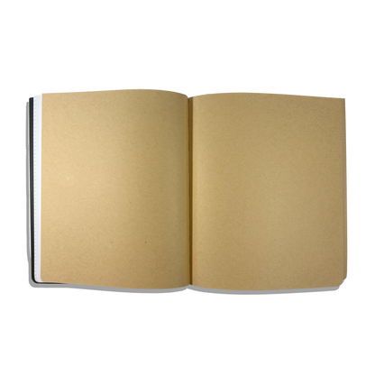 Kraft paper pages in an opened OOLY's The Paper Works Sketchbook on a white background